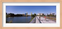 Bicyclists along the Sacramento River with Tower Bridge in background, Sacramento, Sacramento County, California, USA Fine Art Print