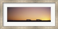 Silhouette of two trucks moving on a highway, Interstate 5, California, USA Fine Art Print