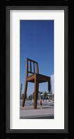 Woman standing under a sculpture of large broken chair, Geneva, Switzerland Fine Art Print