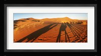 Shadows of camel riders in the desert at sunset, Sahara Desert, Morocco Fine Art Print