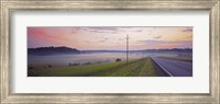 Country road and telephone lines splitting farmlands at dawn, Finland Fine Art Print