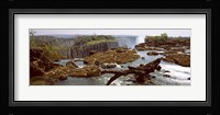 Log on the rocks at the top of the Victoria Falls with Victoria Falls Bridge in the background, Zimbabwe Fine Art Print