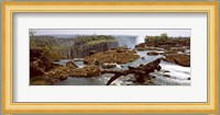 Log on the rocks at the top of the Victoria Falls with Victoria Falls Bridge in the background, Zimbabwe Fine Art Print