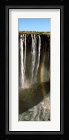 Rainbow forms in the water spray in the gorge at Victoria Falls, Zimbabwe Fine Art Print