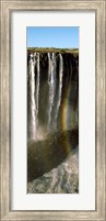 Rainbow forms in the water spray in the gorge at Victoria Falls, Zimbabwe Fine Art Print