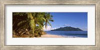 Palm trees grow out over a small beach with Silhouette Island in the background, Seychelles Fine Art Print