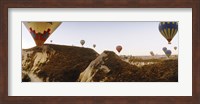 Hot air balloons soaring over a mountain ridge, Cappadocia, Central Anatolia Region, Turkey Fine Art Print