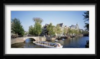 Netherlands, Amsterdam, tour boat in channel Fine Art Print