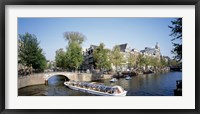 Netherlands, Amsterdam, tour boat in channel Fine Art Print