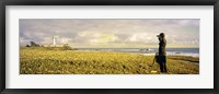 USA, California, Businessman standing holding binoculars and looking at the lighthouse Fine Art Print