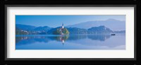 Reflection of mountains and buildings in water, Lake Bled, Slovenia Fine Art Print