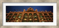 Low angle view of a building lit up at night, Harrods, London, England Fine Art Print