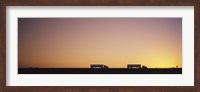Silhouette of two trucks moving on a highway, Interstate 5, California, USA Fine Art Print