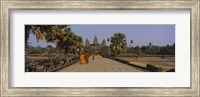 Two monks walking in front of an old temple, Angkor Wat, Siem Reap, Cambodia Fine Art Print