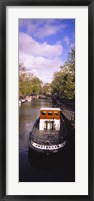 Tourboat docked in a channel, Amsterdam, Netherlands Fine Art Print