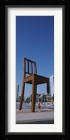 Woman standing under a sculpture of large broken chair, Geneva, Switzerland Fine Art Print