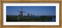 Traditional windmills at a riverbank, Kinderdijk, Rotterdam, Netherlands Fine Art Print