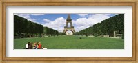 Tourists sitting in a park with a tower in the background, Eiffel Tower, Paris, Ile-de-France, France Fine Art Print