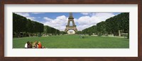 Tourists sitting in a park with a tower in the background, Eiffel Tower, Paris, Ile-de-France, France Fine Art Print