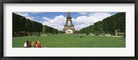 Tourists sitting in a park with a tower in the background, Eiffel Tower, Paris, Ile-de-France, France Fine Art Print