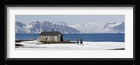 Two hikers standing on the beach near a hunting cabin, Bellsund, Spitsbergen, Svalbard Islands, Norway Fine Art Print