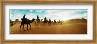 Tourists riding camels through the Sahara Desert landscape led by a Berber man, Morocco Fine Art Print