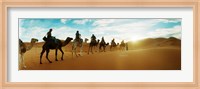 Tourists riding camels through the Sahara Desert landscape led by a Berber man, Morocco Fine Art Print