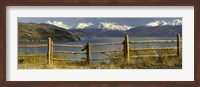 Fence in front of a lake with mountains in the background, Lake General Carrera, Andes, Patagonia, Chile Fine Art Print