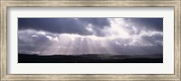 Sunbeams radiating through dark clouds over rolling hills, Dartmoor, Devon, England Fine Art Print