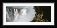 Woman looking at a rainbow over the Victoria Falls, Zimbabwe Fine Art Print