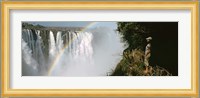 Woman looking at a rainbow over the Victoria Falls, Zimbabwe Fine Art Print