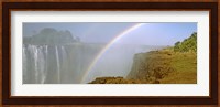 Rainbow form in the spray created by the water cascading over the Victoria Falls, Zimbabwe Fine Art Print