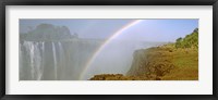 Rainbow form in the spray created by the water cascading over the Victoria Falls, Zimbabwe Framed Print