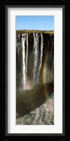 Rainbow forms in the water spray in the gorge at Victoria Falls, Zimbabwe Fine Art Print