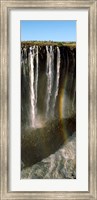 Rainbow forms in the water spray in the gorge at Victoria Falls, Zimbabwe Fine Art Print