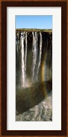 Rainbow forms in the water spray in the gorge at Victoria Falls, Zimbabwe Fine Art Print