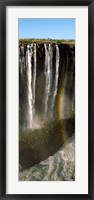 Rainbow forms in the water spray in the gorge at Victoria Falls, Zimbabwe Fine Art Print