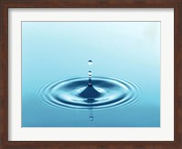 Drops rising from ripples in blue water Fine Art Print