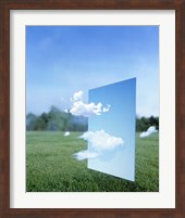 White clouds passing through a pale blue horizontal of sky with green grass, trees and sky in the distance Fine Art Print