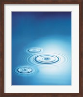 Three rings in blue water with bright light reflection Fine Art Print