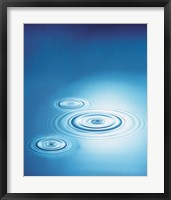 Three rings in blue water with bright light reflection Fine Art Print
