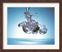 Iridescent water bubble formation floating above the surface of deep blue water Fine Art Print