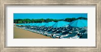 Parasols with lounge chairs on a private beach in summer morning light, French Riviera, France Fine Art Print
