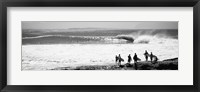 Silhouette of surfers standing on the beach, Australia (black and white) Framed Print