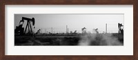 Oil drills in a field, Maricopa, Kern County, California (black and white) Fine Art Print
