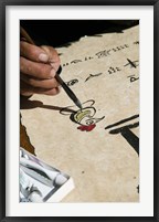 Chinese calligrapher painting calligraphy on a paper at the Dongba Place, Old Town, Lijiang, Yunnan Province, China Fine Art Print