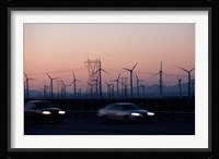 Cars moving on road with wind turbines in background at dusk, Palm Springs, Riverside County, California, USA Framed Print
