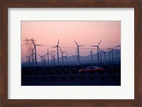 Car moving on a road with wind turbines in background at dusk, Palm Springs, Riverside County, California, USA Fine Art Print