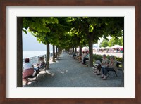 People sitting on benches among trees at lakeshore, Lake Como, Cernobbio, Lombardy, Italy Fine Art Print