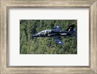 A Hawk T1 trainer aircraft of the Royal Air Force flying over a forest in North Wales Fine Art Print